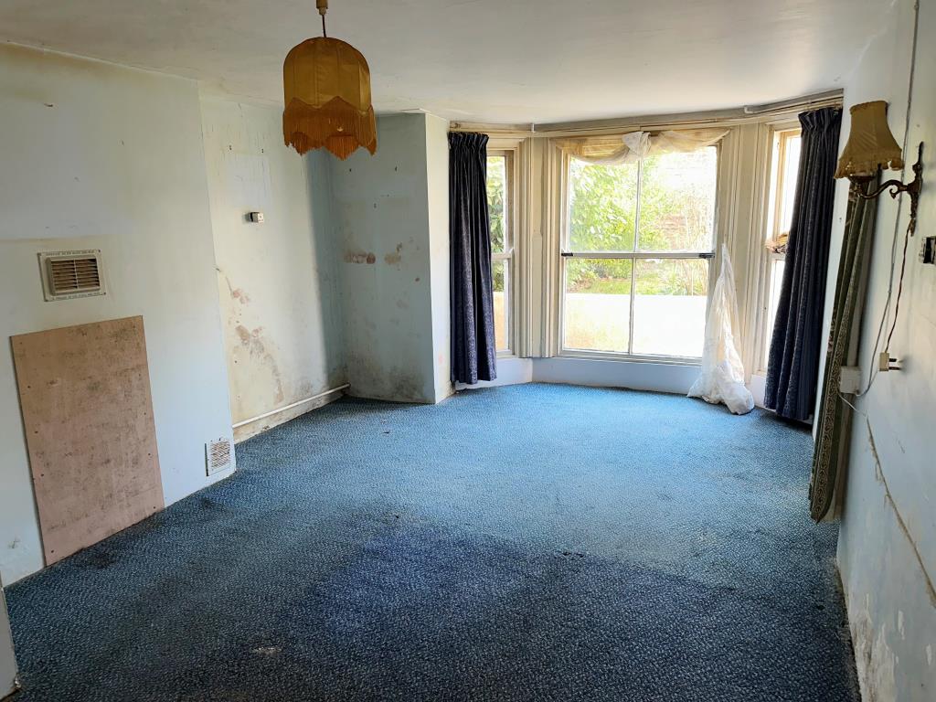 Lot: 141 - THREE-BEDROOM MAISONETTE FOR IMPROVEMENT - Bedroom located on the ground floor with bay window